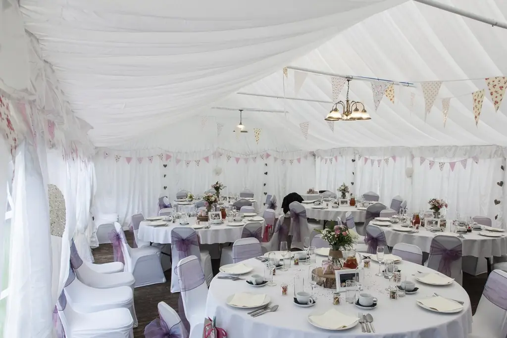 Reception tent with round tables and chairs